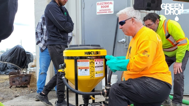 Green Drop worker using advanced tools for soil and tree diagnostics