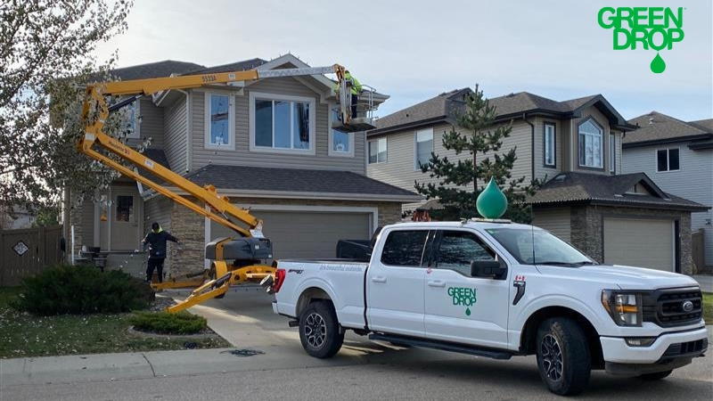 Green Drop workers using a lift to set up holiday decoration