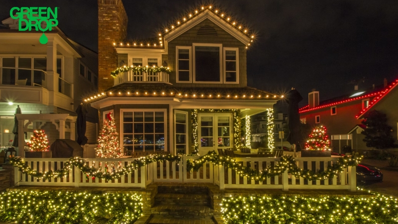 Green Drop holiday lights set up on a house and front porch