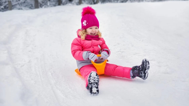 Child sliding on snow