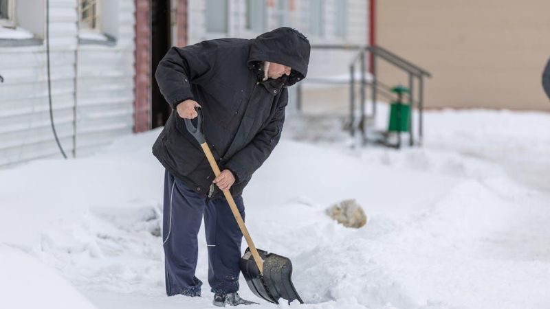 Man shoveling snow on the street