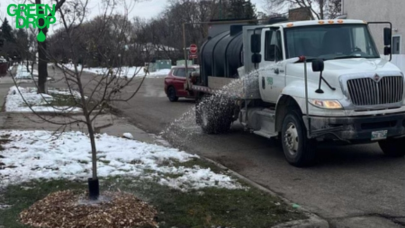 Green Drop truck watering during winter