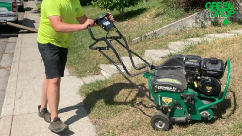 Green Drop worker aerating a lawn in Winnipeg