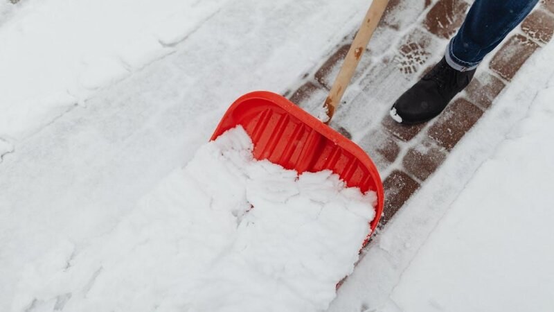 Person shovelling snow on the sidewalk